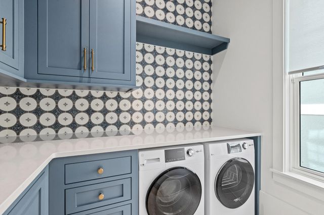 a living room with furniture and a kitchen