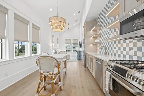 a kitchen with stainless steel appliances granite countertop a sink and cabinets