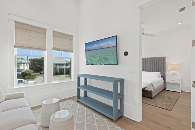 a bedroom with a bed and a painting on the wall