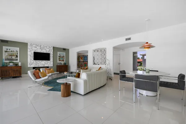 a living room with fireplace furniture and a flat screen tv