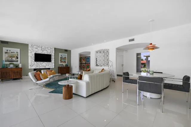 a living room with fireplace furniture and a flat screen tv