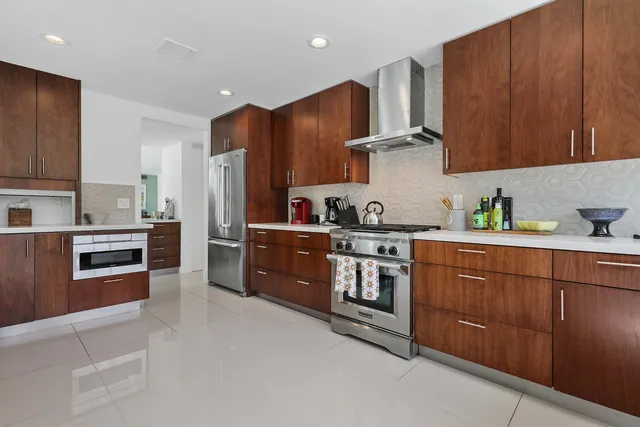 a kitchen with stainless steel appliances granite countertop a refrigerator stove and sink
