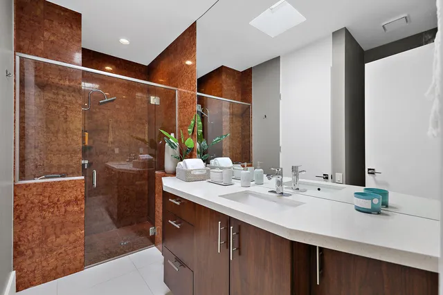 a bathroom with a sink double vanity and shower