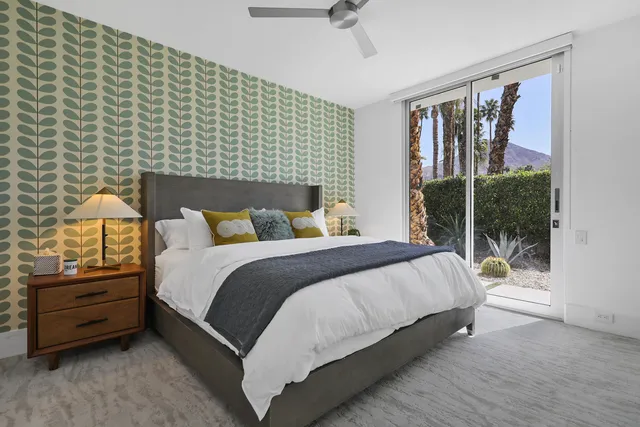 a bedroom with a bed and a night stand