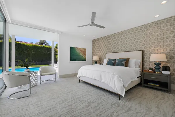 a bedroom with a large bed and a large window