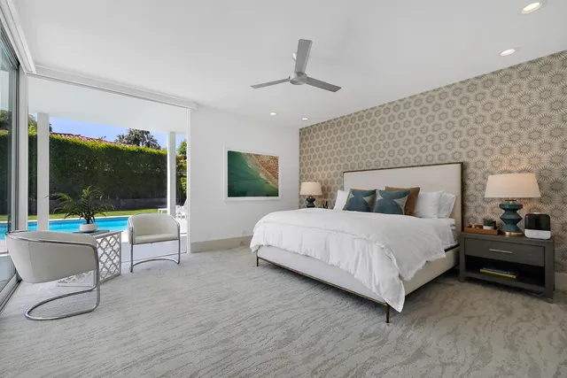 a bedroom with a large bed and a large window