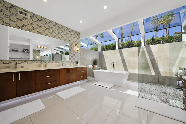 a bathroom with a tub sink and mirror