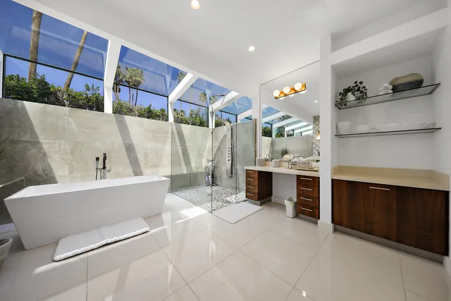 a bathroom with a tub sink and mirror