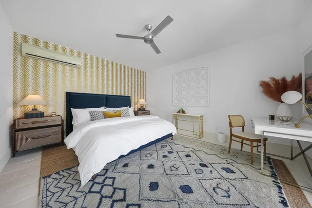 a bathroom with a sink a mirror and a potted plant