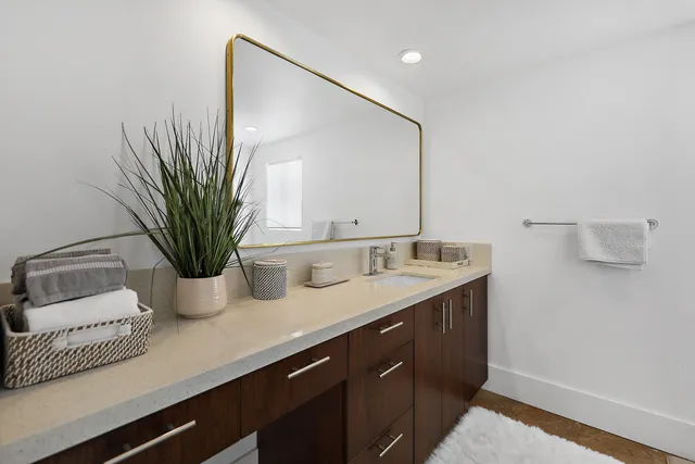 a view of a lush green field with mountains in the background