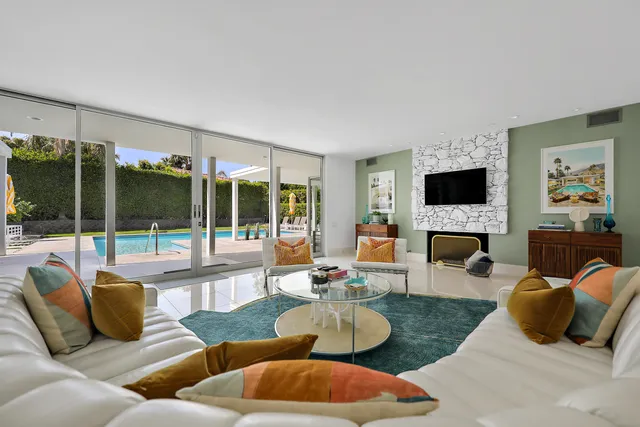 a living room with fireplace furniture and a flat screen tv