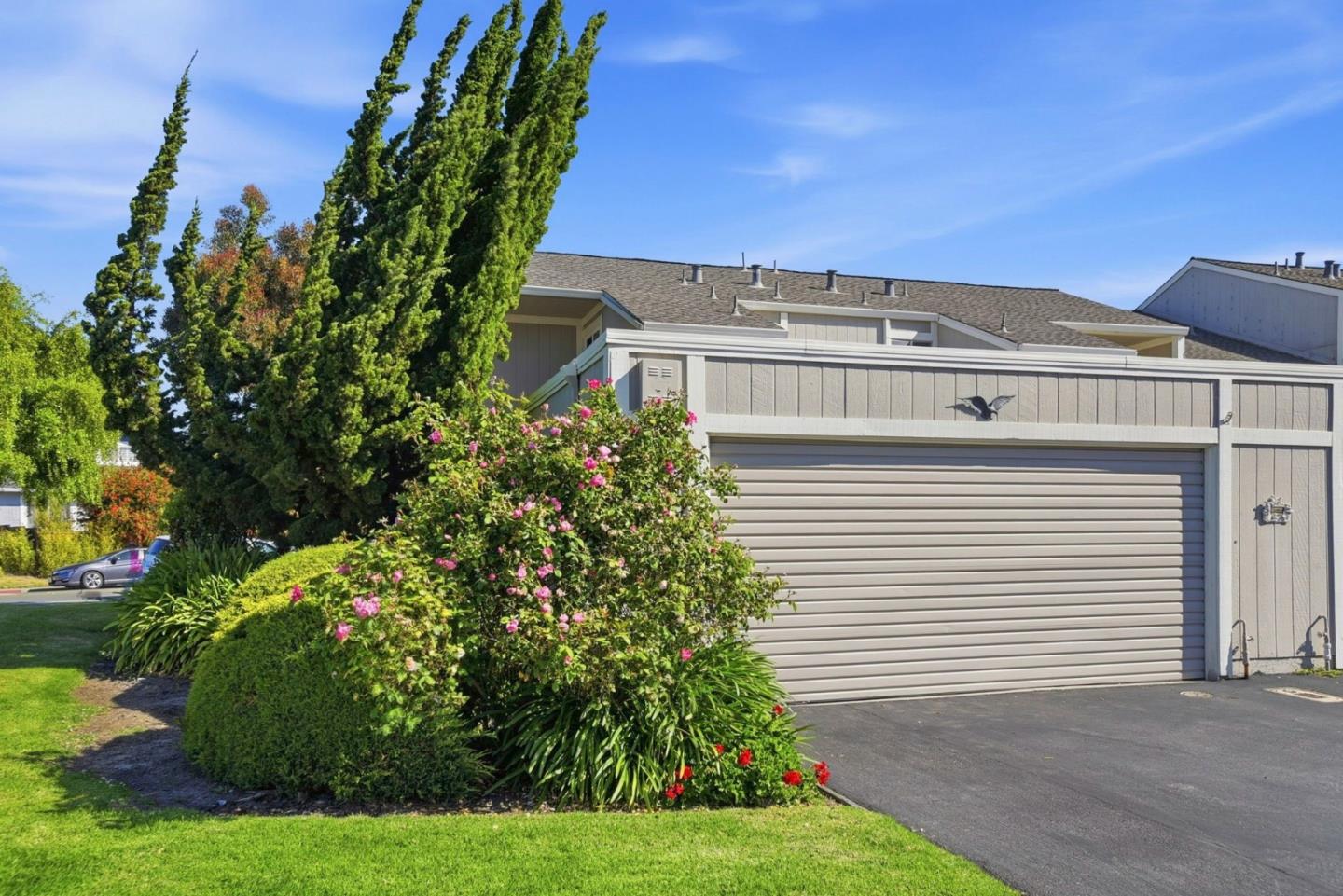 a front view of a house with a garden
