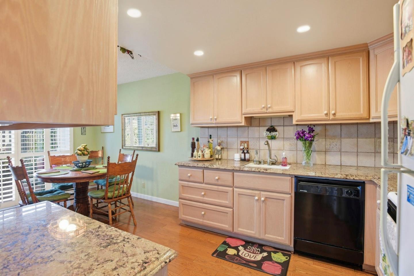 815 Rigel Lane Foster City, CA 94404 - Photo 15 of 48 a kitchen with stainless steel appliances granite countertop a stove a sink dishwasher and cabinets with wooden floor