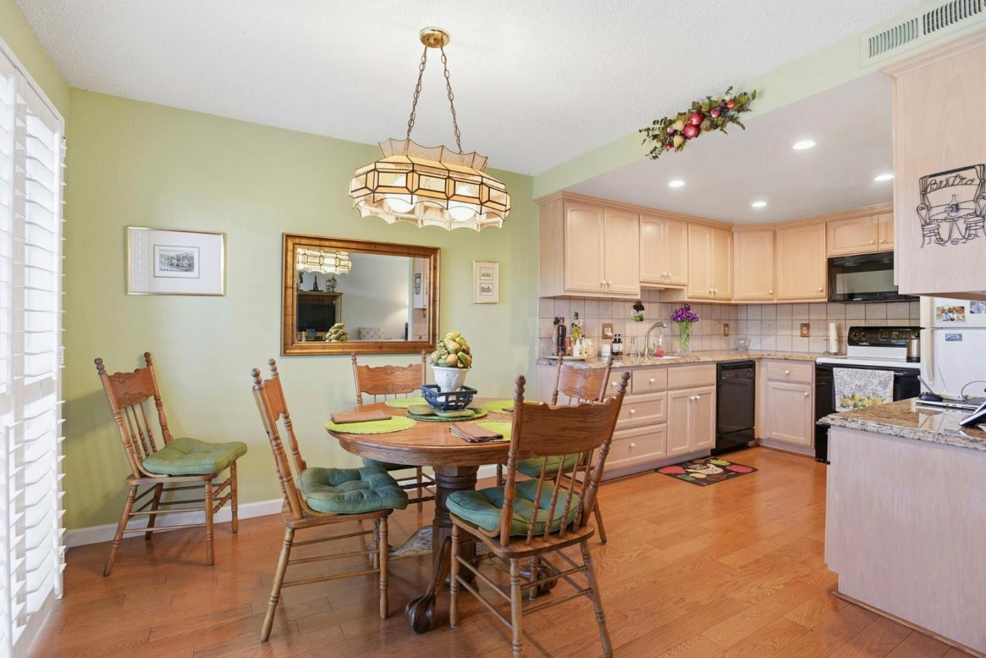 815 Rigel Lane Foster City, CA 94404 - Photo 16 of 48 a view of a dining room with furniture a chandelier and wooden floor