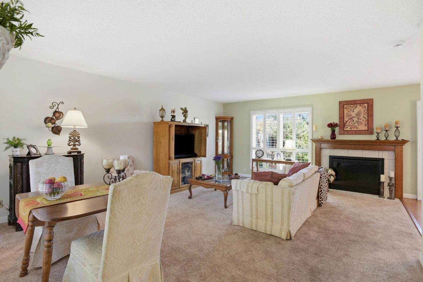 815 Rigel Lane Foster City, CA 94404 - Photo 19 of 48 a living room with furniture a fireplace and a flat screen tv