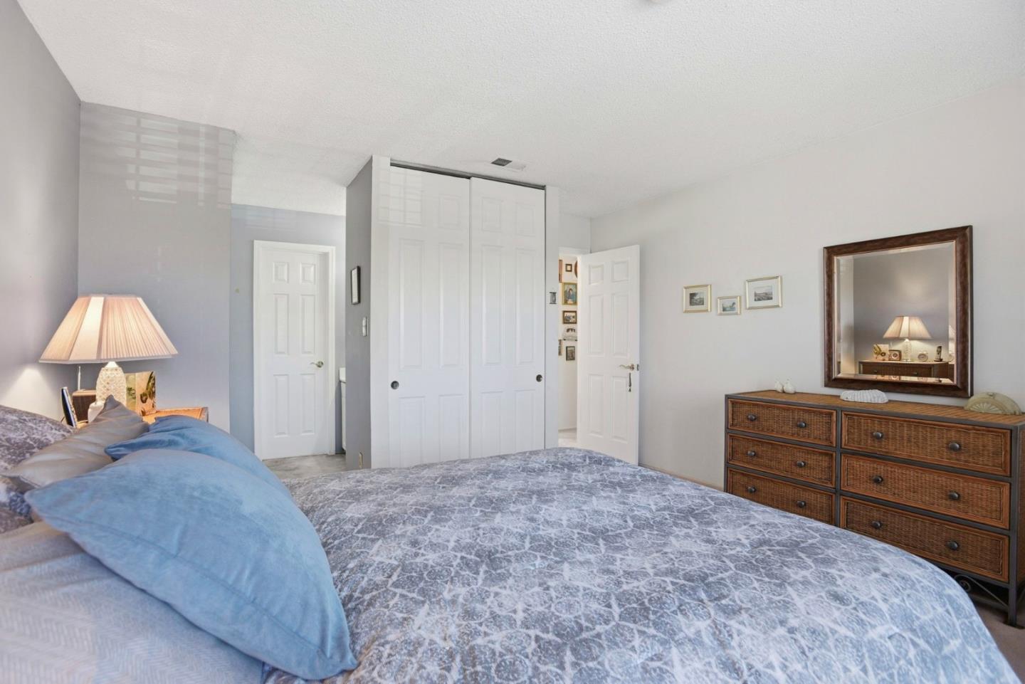 815 Rigel Lane Foster City, CA 94404 - Photo 24 of 48 a bedroom with a bed and a lamp on dresser