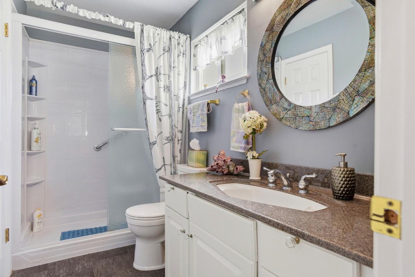 815 Rigel Lane Foster City, CA 94404 - Photo 30 of 48 a bathroom with a granite countertop sink and a mirror