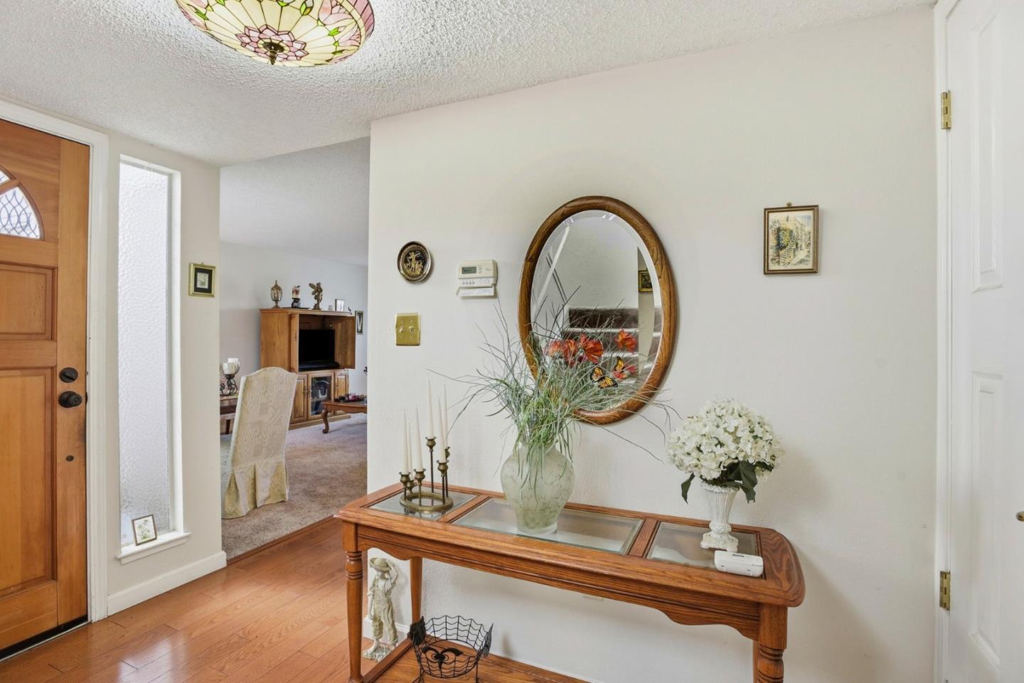 815 Rigel Lane Foster City, CA 94404 - Photo 6 of 48 a picture of a room with a table and a potted plant