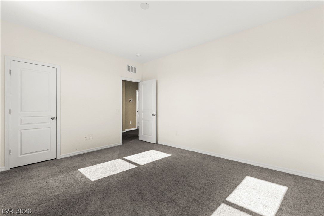 11048 Prairie Grove Road Las Vegas, NV 89179 - Photo 58 of 75 An airy bedroom with fresh carpet, ready for your personal touch.