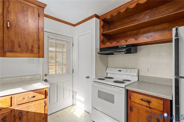 a kitchen with stainless steel appliances granite countertop a sink and a refrigerator