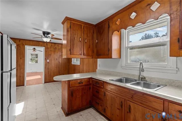 a white refrigerator freezer and a wooden table sitting in a kitchen