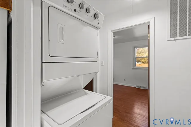 a view of a hallway with wooden floor and entryway