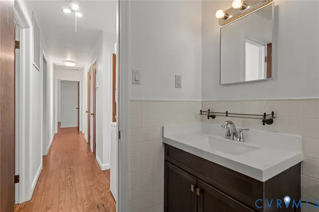 an empty room with wooden floor and closet