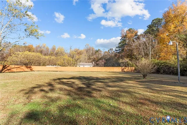 a view of yard with large trees