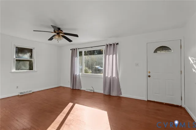 wooden floor in an empty room with a window