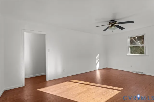 a view of kitchen with granite countertop cabinets and window