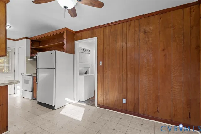 a view of a kitchen with a refrigerator and a sink