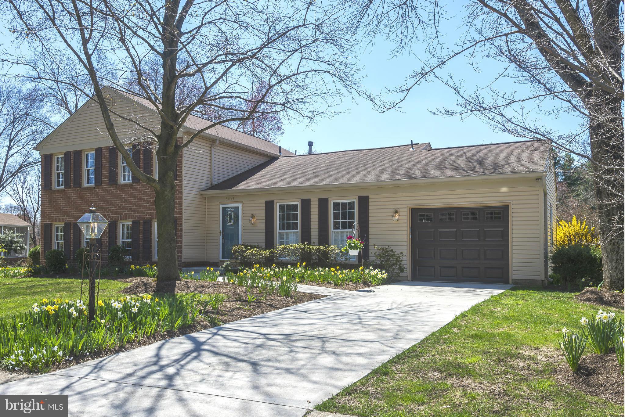 5054 Whetstone Road Columbia, MD 21044 - Photo 2 of 30 a front view of a house with a yard and potted plants