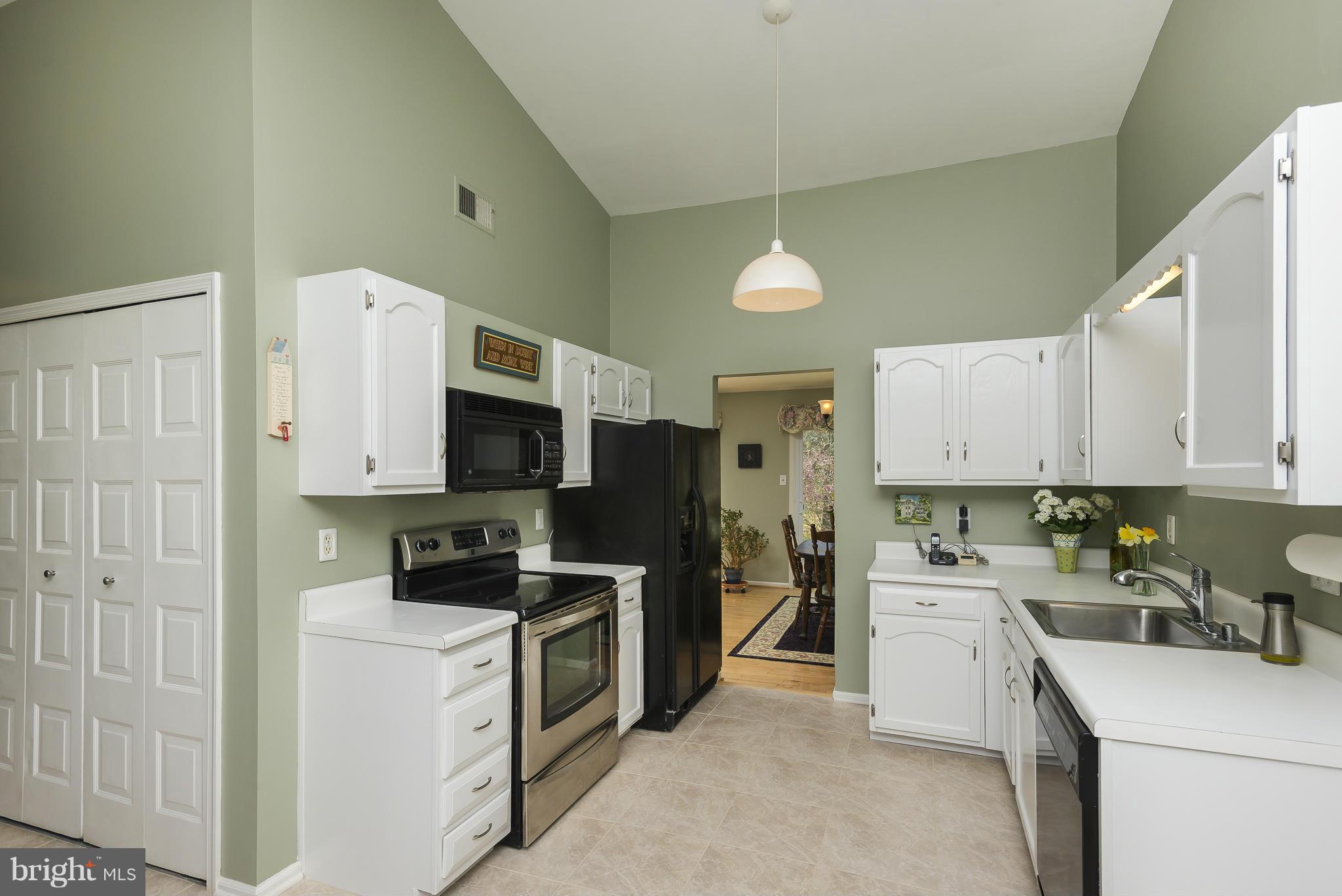 5054 Whetstone Road Columbia, MD 21044 - Photo 12 of 30 a kitchen with a sink a stove and refrigerator