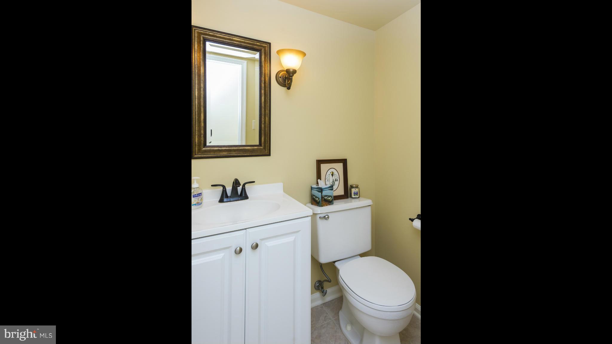 5054 Whetstone Road Columbia, MD 21044 - Photo 15 of 30 a bathroom with a toilet a sink and mirror