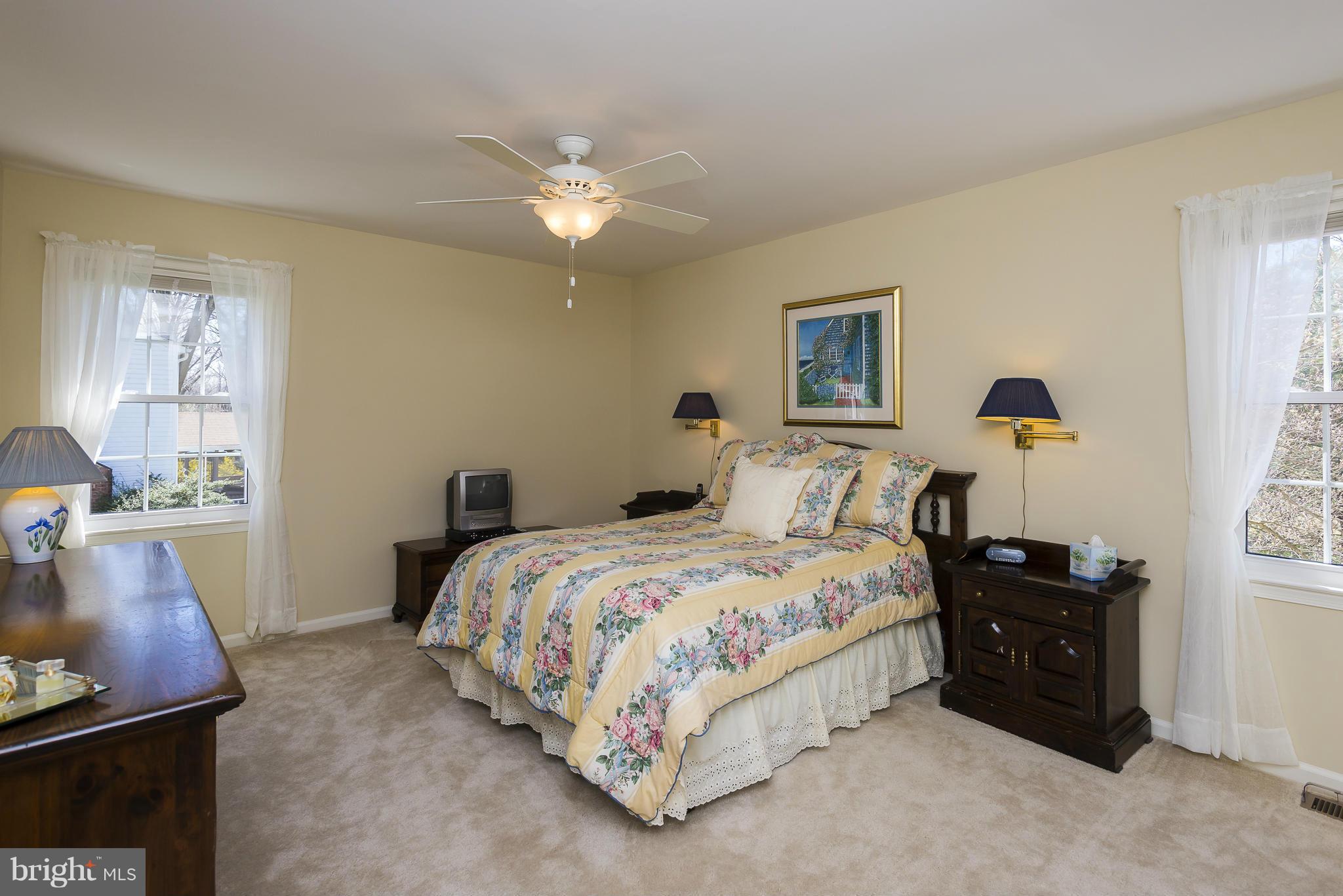 5054 Whetstone Road Columbia, MD 21044 - Photo 18 of 30 a bedroom with a bed and wooden floor