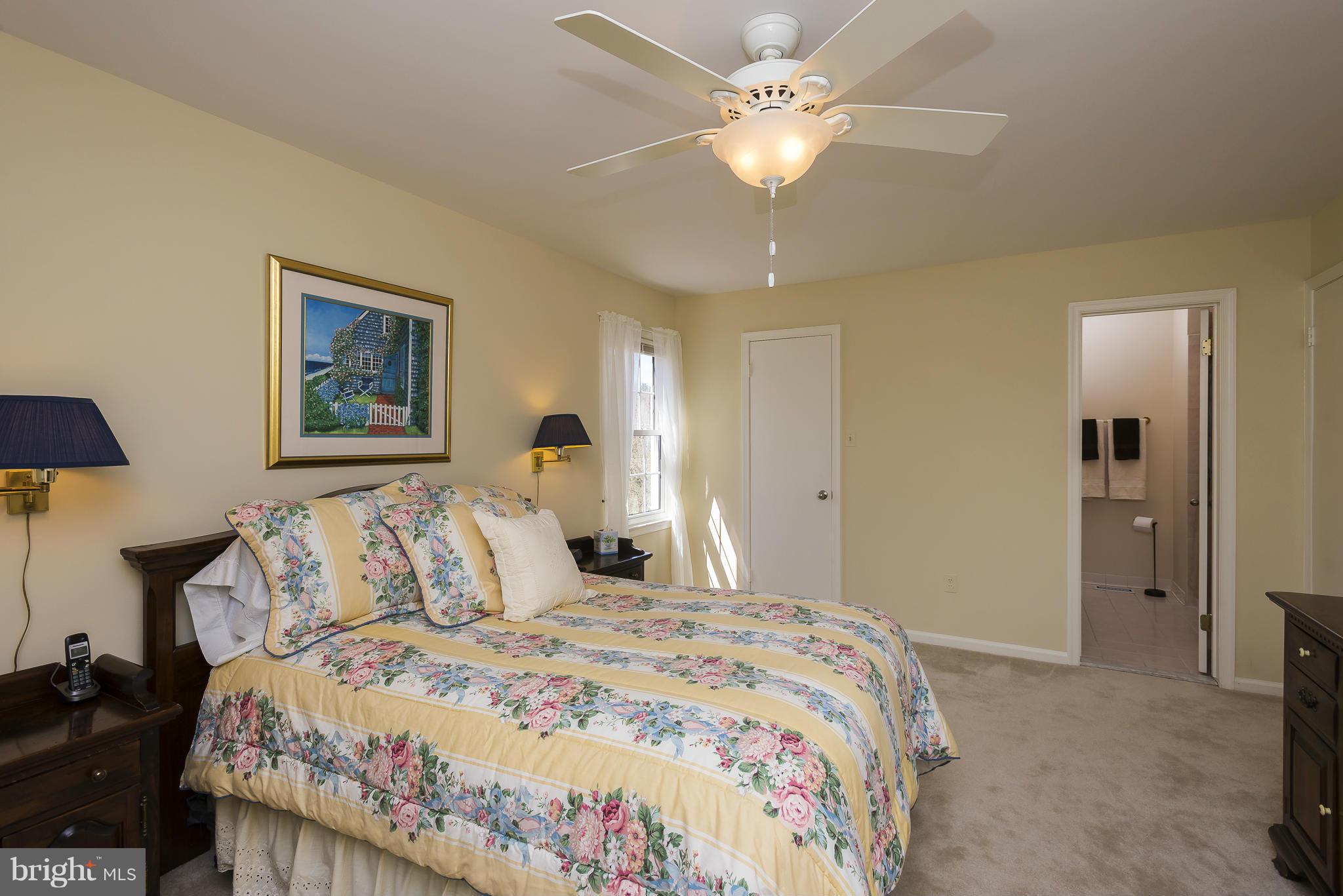 5054 Whetstone Road Columbia, MD 21044 - Photo 19 of 30 a bedroom with a large bed and a chandelier