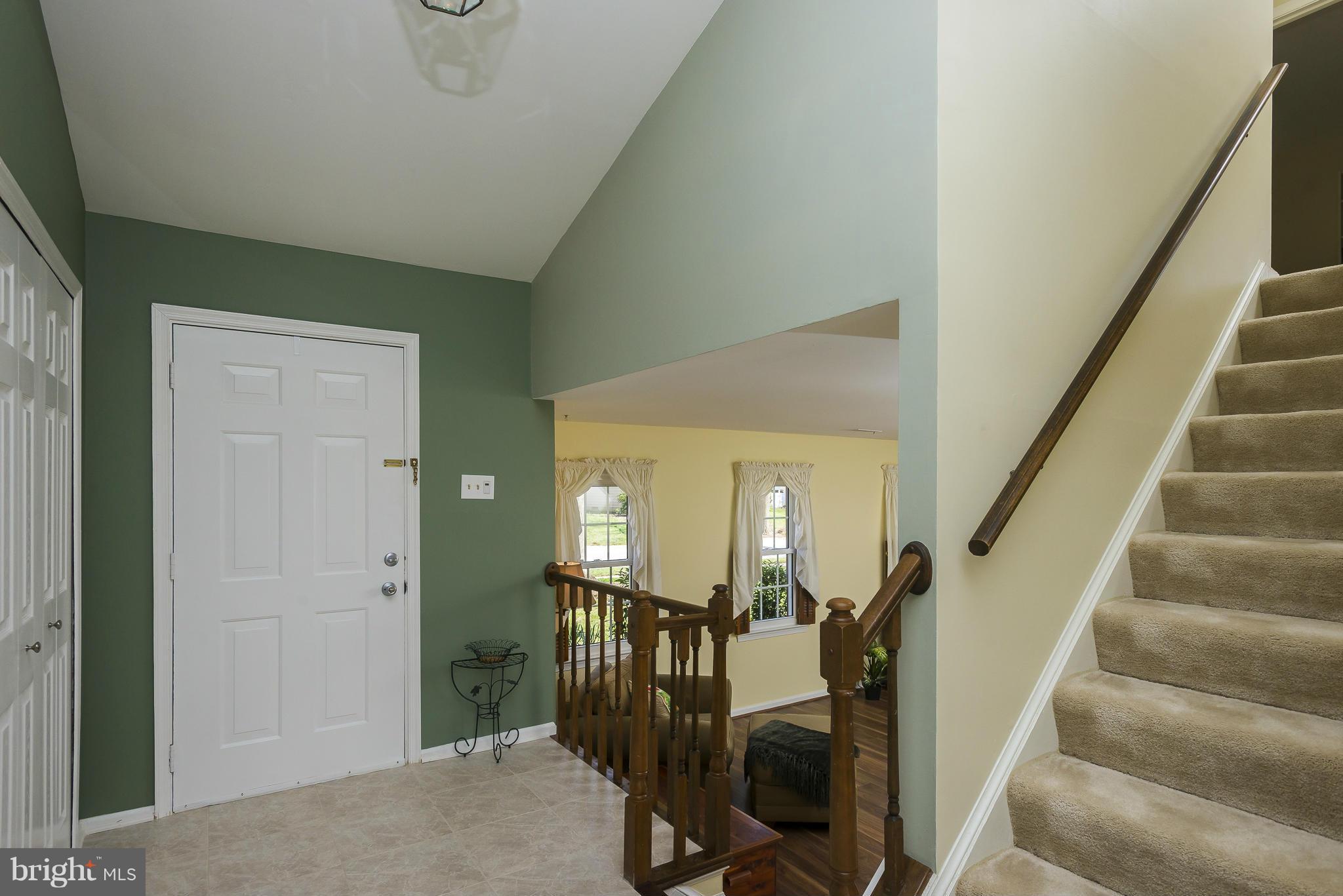 5054 Whetstone Road Columbia, MD 21044 - Photo 6 of 30 a view of a hallway with wooden floor and staircase
