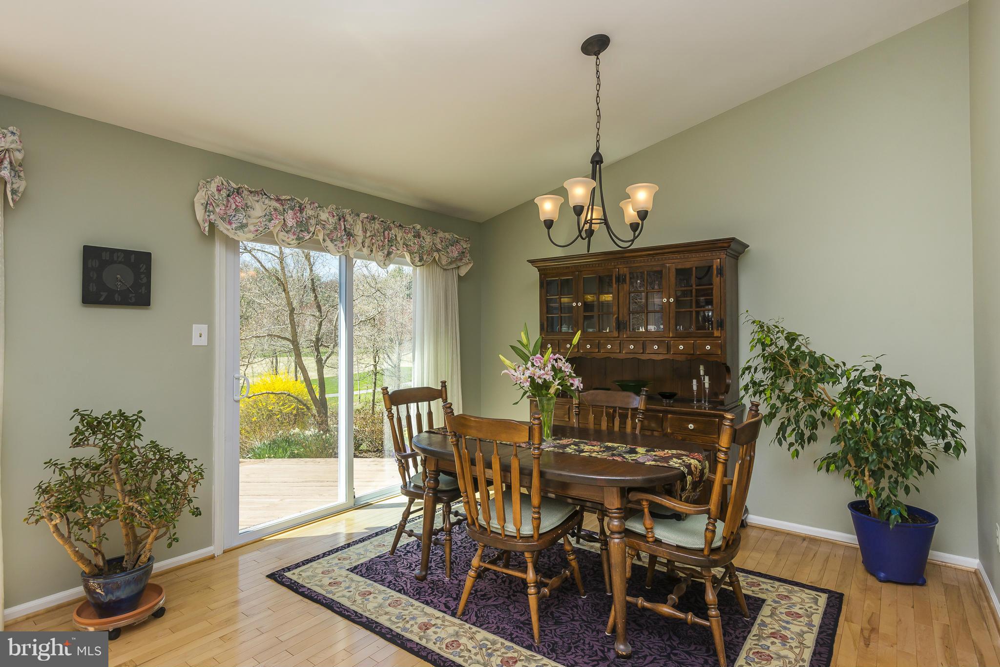 5054 Whetstone Road Columbia, MD 21044 - Photo 9 of 30 a view of a dining room with furniture window and wooden floor