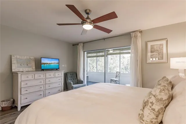 a bedroom with a large bed and a flat tv screen