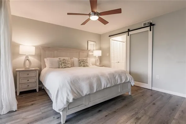 a bedroom with a bed and a ceiling fan