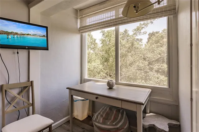 a view of a room that has a bed and a window