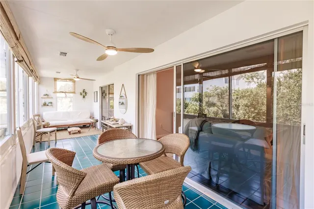 a dining room with furniture a chandelier and wooden floor