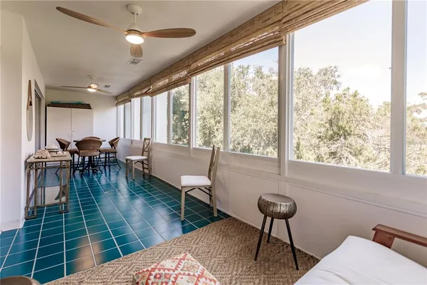 a living room with furniture a table and a large window