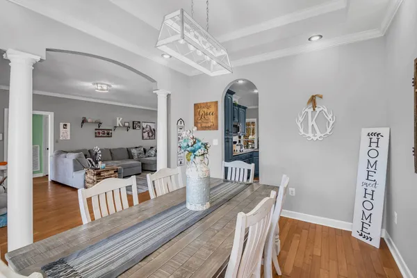 a kitchen with stainless steel appliances kitchen island granite countertop a refrigerator stove top oven and cabinets