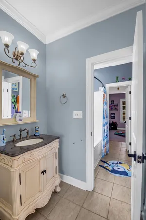 a living room with furniture a flat screen tv and a couch