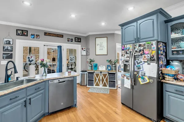 a front view of house with yard and trees around