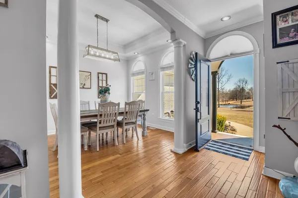 a living room with furniture and a chandelier