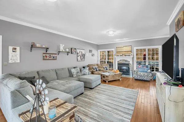 a living room with furniture and wooden floor
