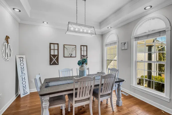 a living room with furniture a flat screen tv and a floor to ceiling window