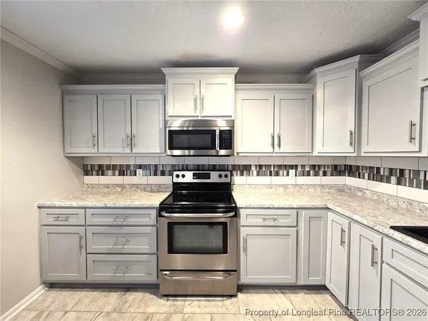 a kitchen with cabinets appliances and a sink